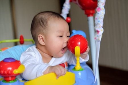 Baby playing in a jumper