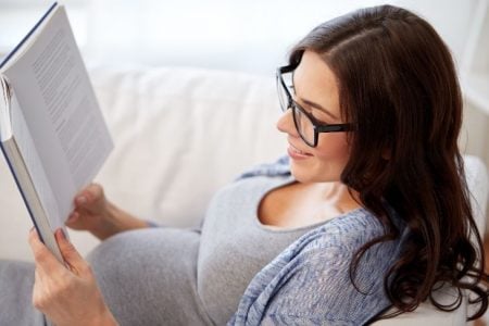 Pregnant woman reading a book