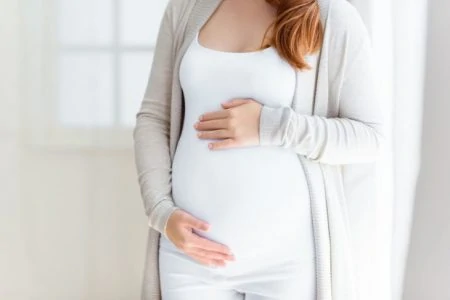 Pregnant woman holding her belly