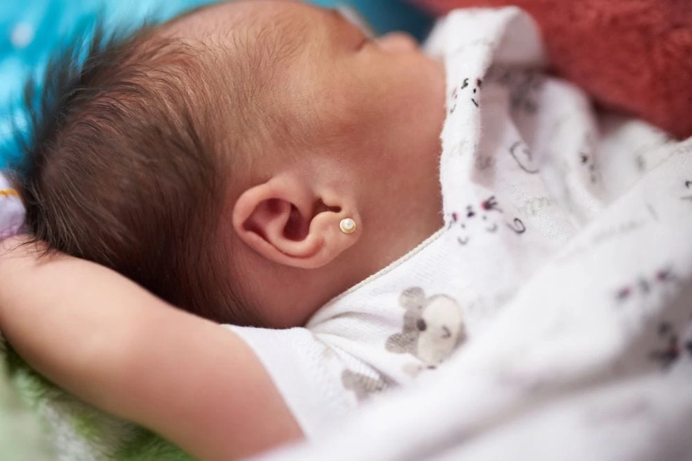 Baby wearing earrings