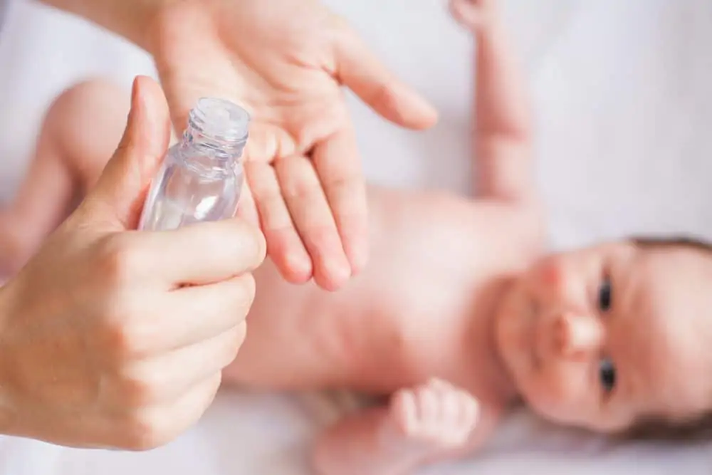 Mom massages baby with oil