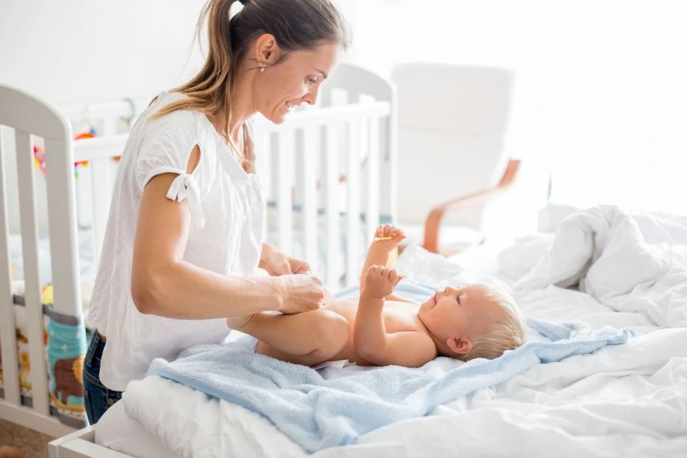 Mom changing her baby's diaper