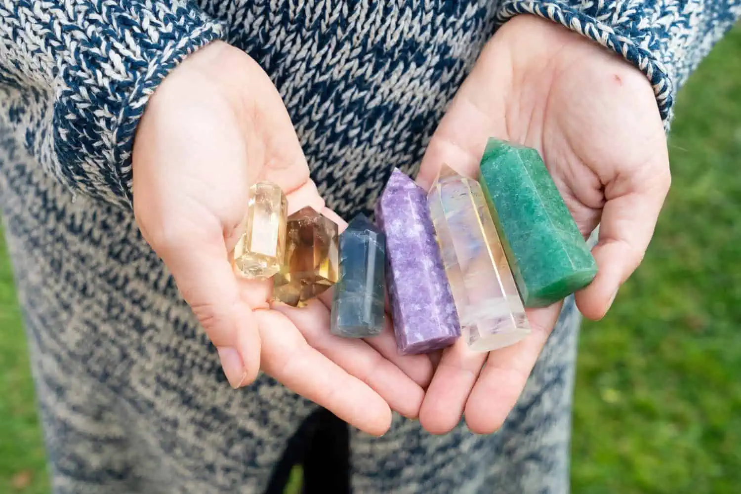 Hand holding set of crystal and gemstones