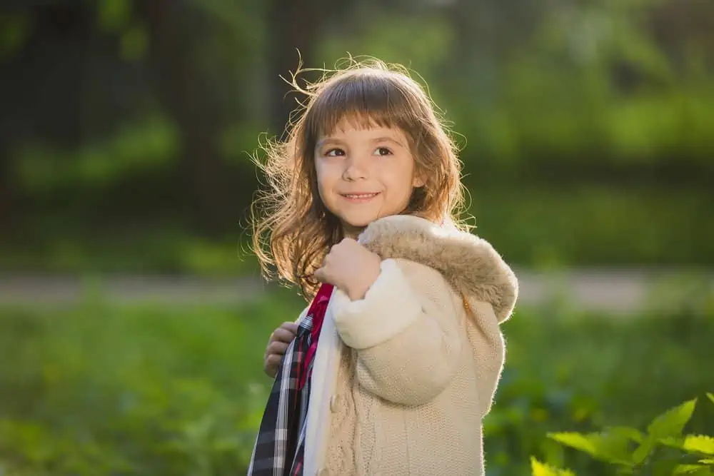 Happy little girl playing in the park.