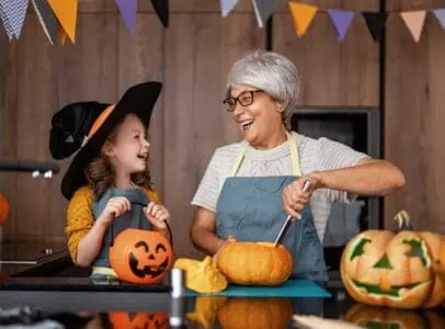 Grandmother and granddaughter having fun preparing for halloween