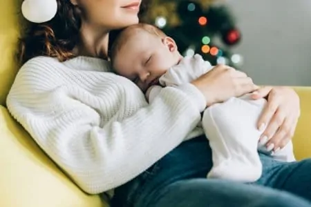 Baby sleeping on mother's chest