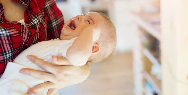 Mother holding crying baby