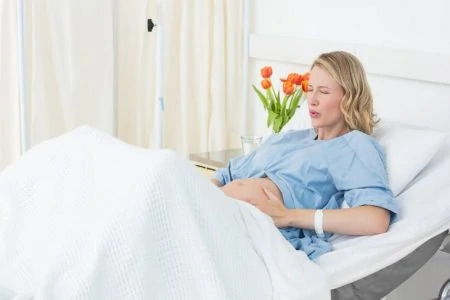 Pregnant woman laying in hospital bed