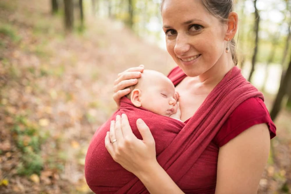 Woman using a stretchy baby wrap